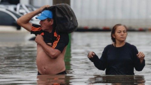 epa11336189 Two people wade through a flooded street in the Navegantes neighborhood in Porto ... epa11336189 Two people wade through a flooded street in the Navegantes neighborhood in Porto ...