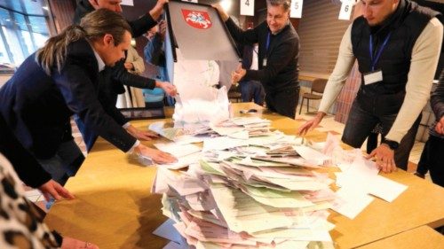 Members of a local electoral commission count ballots at a polling station during the first round of ... Members of a local electoral commission count ballots at a polling station during the first round of ...