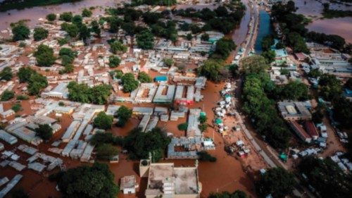 TOPSHOT - This aerial view shows the damages of a main road and houses submerged in water following ... TOPSHOT - This aerial view shows the damages of a main road and houses submerged in water following ...