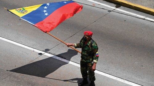 A supporter of Venezuelan President Nicolas Maduro's government waves a Venezuelan flag during a May ... A supporter of Venezuelan President Nicolas Maduro's government waves a Venezuelan flag during a May ...
