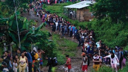 FILE - Migrants heading north line up to take a boat in Bajo Chiquito in the Darien province of ... FILE - Migrants heading north line up to take a boat in Bajo Chiquito in the Darien province of ...