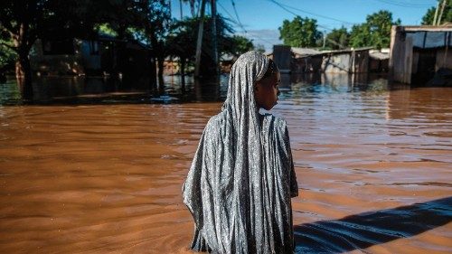 TOPSHOT - A woman wades through flood waters at an inundated residential area in Garissa, on May 9, ... TOPSHOT - A woman wades through flood waters at an inundated residential area in Garissa, on May 9, ...