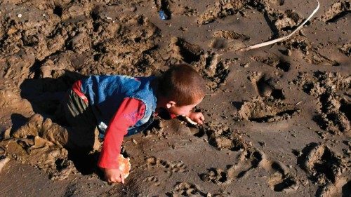 An Afghan child crawls on mud after floods in Burka district of Baghlan province on May 12, 2024. ... An Afghan child crawls on mud after floods in Burka district of Baghlan province on May 12, 2024. ...