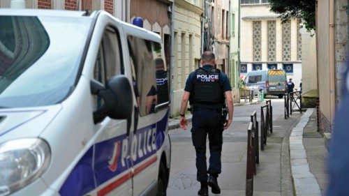 Police walk down a street leading to the synagogue in the Normandy city of Rouen where French police ...
