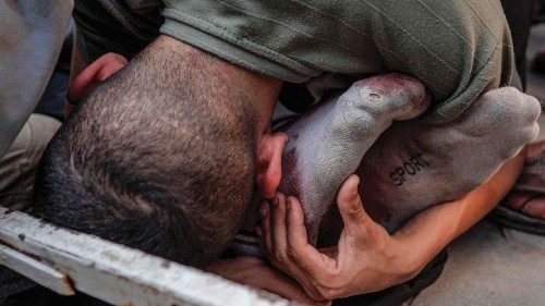 TOPSHOT - A Palestinian man hugs the feet of a victim of Israeli bombardment in Maghazi, in the ... TOPSHOT - A Palestinian man hugs the feet of a victim of Israeli bombardment in Maghazi, in the ...