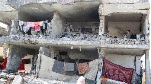 Palestinians stand inside a house destroyed by an Israeli strike, amid the ongoing conflict between ... Palestinians stand inside a house destroyed by an Israeli strike, amid the ongoing conflict between ...
