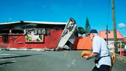 TOPSHOT - A man walks past a damaged supermarket in Noumea, France's Pacific territory of New ... TOPSHOT - A man walks past a damaged supermarket in Noumea, France's Pacific territory of New ...