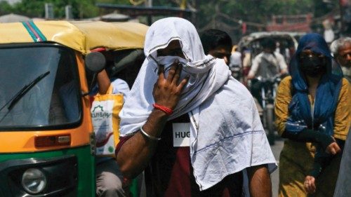 People wearing head scarves walk along a street on a hot summer day in the old quarters of New Delhi ... People wearing head scarves walk along a street on a hot summer day in the old quarters of New Delhi ...