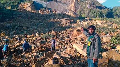 People gather at the site of a landslide in Maip Mulitaka in Papua New Guinea's Enga Province on May ... People gather at the site of a landslide in Maip Mulitaka in Papua New Guinea's Enga Province on May ...