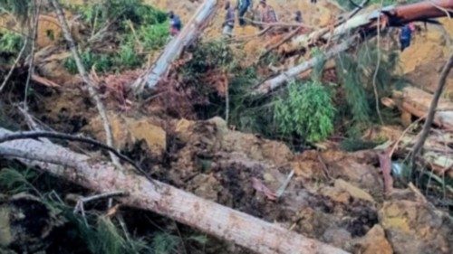 People gather at the site of a landslide in Maip Mulitaka in Papua New Guinea's Enga Province on May ... People gather at the site of a landslide in Maip Mulitaka in Papua New Guinea's Enga Province on May ...