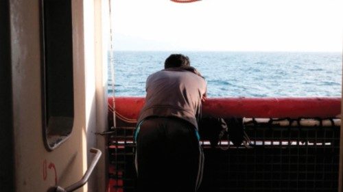 TOPSHOT - A migrant from Bangladesh watches the sunset on the main deck of the Ocean Viking rescue ... TOPSHOT - A migrant from Bangladesh watches the sunset on the main deck of the Ocean Viking rescue ...