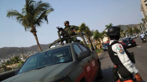 A member of the National Guard and members of the Mexican army patrol near a crime scene where two ... A member of the National Guard and members of the Mexican army patrol near a crime scene where two ...