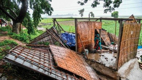 A woman collects clothes from her damaged house in the Hatisila area on the outskirts of Guwahati on ... A woman collects clothes from her damaged house in the Hatisila area on the outskirts of Guwahati on ...