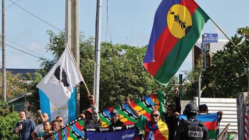 People demonstrate as French President Emmanuel Macron's motorcade drives past in Noumea, France's ... People demonstrate as French President Emmanuel Macron's motorcade drives past in Noumea, France's ...