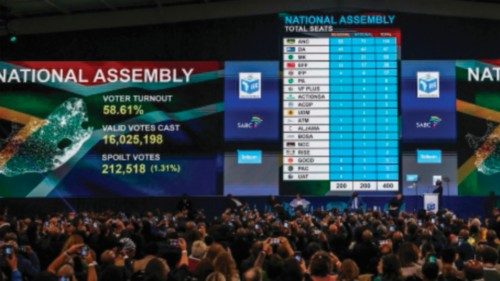 Guests and political party representatives use their mobile phones to record the electronic results ... Guests and political party representatives use their mobile phones to record the electronic results ...