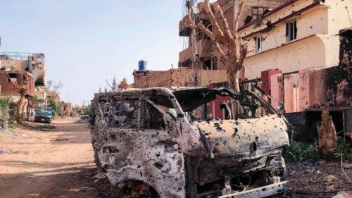 This picture taken on May 30, 2024, shows a burnt vehicle in front of damaged shop in Omdurman. War ... This picture taken on May 30, 2024, shows a burnt vehicle in front of damaged shop in Omdurman. War ...