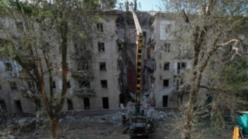 Rescuers work at the site of a missile attack in Lugansk, Russian-controlled Ukraine, on June 7, ...