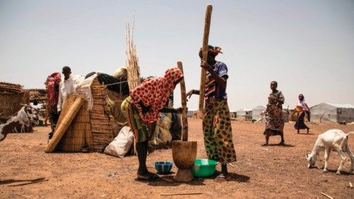 TOPSHOT - Displaced women pound millet at the Torodi IDP displacement camp in Dori, on May 30, 2024. ... TOPSHOT - Displaced women pound millet at the Torodi IDP displacement camp in Dori, on May 30, 2024. ...