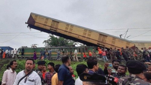 Rescue workers along with people gather at the site of a train collision after the accident in ... Rescue workers along with people gather at the site of a train collision after the accident in ...