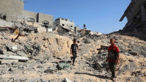 Palestinian children check the rubble of a destroyed building following Israeli bombardment in Khan ... Palestinian children check the rubble of a destroyed building following Israeli bombardment in Khan ...