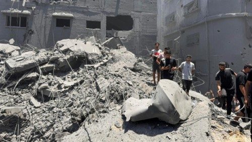 Palestinians search for casualties at the site of Israeli strikes on houses, amid Israel-Hamas ...