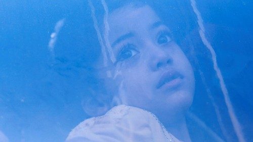 A Palestinian girl, who is a patient, looks through the window of a vehicle before she is ... A Palestinian girl, who is a patient, looks through the window of a vehicle before she is ...