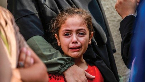 EDITORS NOTE: Graphic content / TOPSHOT - A girl cries as she and her relatives mourn the death of ... EDITORS NOTE: Graphic content / TOPSHOT - A girl cries as she and her relatives mourn the death of ...