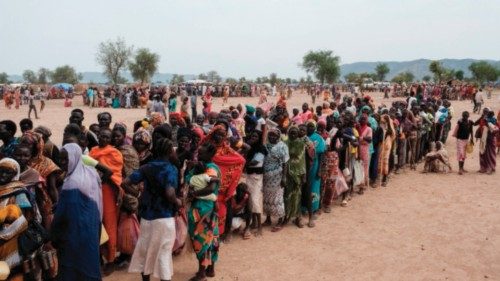 TOPSHOT - People line up to register for a potential food aid delivery at a camp for internally ...