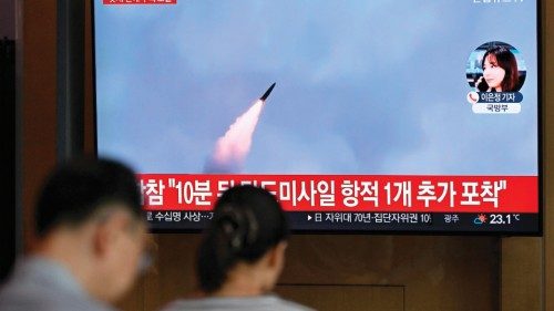 People watch a television screen showing a news broadcast with file footage of a North Korean ... People watch a television screen showing a news broadcast with file footage of a North Korean ...