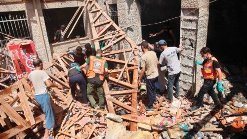 Palestinians rescuers search the rubble and debris of the Latin Patriarchate Holy Family School ... Palestinians rescuers search the rubble and debris of the Latin Patriarchate Holy Family School ...