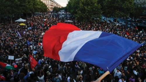 A protester hold a French flag as people gather at the Place de la Republique after partial results ... A protester hold a French flag as people gather at the Place de la Republique after partial results ...