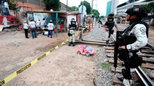 National Guard members stand guard at the area where the collective 'Corazones Unidos En Busca de ...