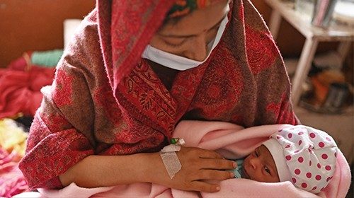 This photograph taken on April 25, 2023 shows Manu Bala holding her newborn daughter inside a ... This photograph taken on April 25, 2023 shows Manu Bala holding her newborn daughter inside a ...
