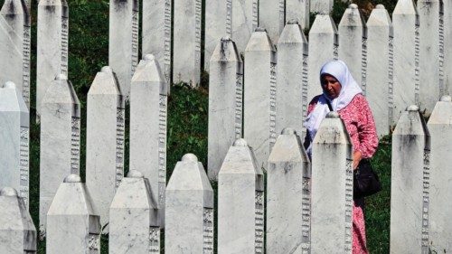 Bosnian Muslim survivor of the Srebrenica 1995 genocide, walks among headstones as she visits graves ... Bosnian Muslim survivor of the Srebrenica 1995 genocide, walks among headstones as she visits graves ...