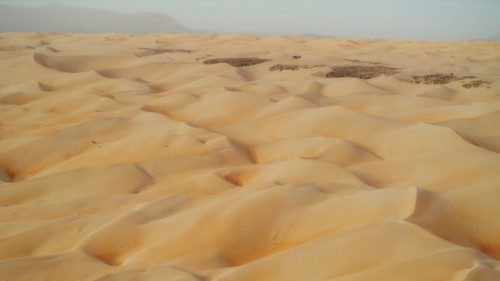 TOPSHOT - A general view of the dunes of the desert next to the village of Oasis of Maaden el ... TOPSHOT - A general view of the dunes of the desert next to the village of Oasis of Maaden el ...