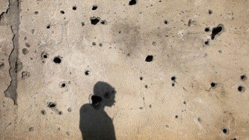 A Palestinians casts his shadow on a damaged wall as he inspects the site of an Israeli strike, ... A Palestinians casts his shadow on a damaged wall as he inspects the site of an Israeli strike, ...