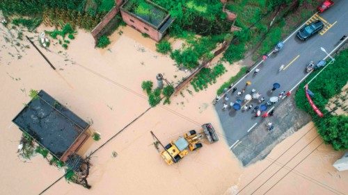 The aerial photo taken on July 11, 2024 shows local residents being evacuated by a wheel loader at a ...