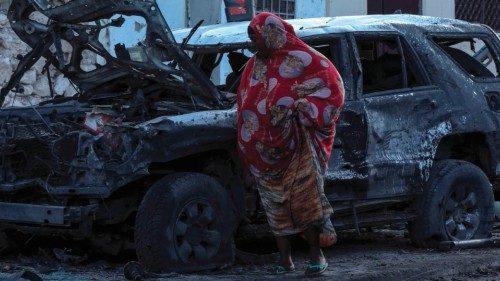 A woman walks past debris and destruction at a cafe in Mogadishu on July 15, 2024 following a car ... A woman walks past debris and destruction at a cafe in Mogadishu on July 15, 2024 following a car ...