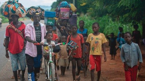 TOPSHOT - Displaced people from the province of Cabo Delgado walk through the streets of Namapa, ... TOPSHOT - Displaced people from the province of Cabo Delgado walk through the streets of Namapa, ...