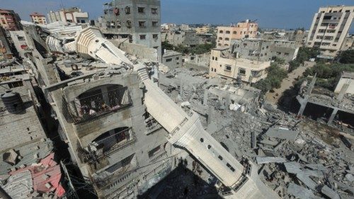 The collapsed minaret of Abdullah Azzam mosque leans against a house after the mosque was hit by an ... The collapsed minaret of Abdullah Azzam mosque leans against a house after the mosque was hit by an ...