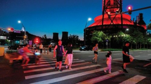 People walk past a steel mill-turned-urban area at an industrial heritage site in the Shougang park ... People walk past a steel mill-turned-urban area at an industrial heritage site in the Shougang park ...
