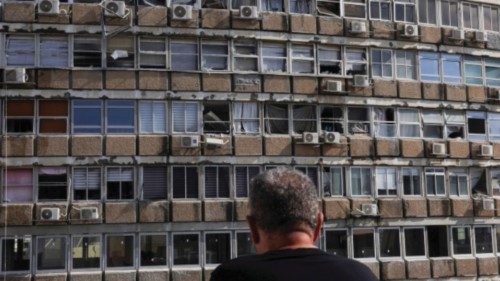 A man looks at a building damaged at the site of an explosion, amid the Israel-Hamas conflict in Tel ... A man looks at a building damaged at the site of an explosion, amid the Israel-Hamas conflict in Tel ...