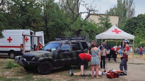 Medical workers treat a wounded local resident at a site of a residential building damaged during a ... Medical workers treat a wounded local resident at a site of a residential building damaged during a ...
