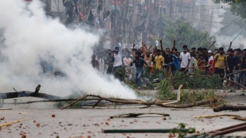 People gesture near smoke as protesters clash with Border Guard Bangladesh (BGB) and the police ... People gesture near smoke as protesters clash with Border Guard Bangladesh (BGB) and the police ...