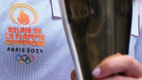 TOPSHOT - A torch bearer holds the Olympic torch during the Olympic Torch Relay in Vincennes, near ... TOPSHOT - A torch bearer holds the Olympic torch during the Olympic Torch Relay in Vincennes, near ...