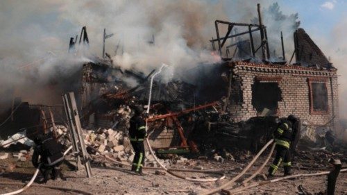 TOPSHOT - Rescuers put out a fire in a private house destroyed during a missile attack in ... TOPSHOT - Rescuers put out a fire in a private house destroyed during a missile attack in ...
