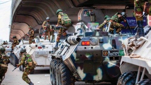 TOPSHOT - Bangladeshi soldiers disembark armored vehicles as they patrol the streets to disperse the ... TOPSHOT - Bangladeshi soldiers disembark armored vehicles as they patrol the streets to disperse the ...