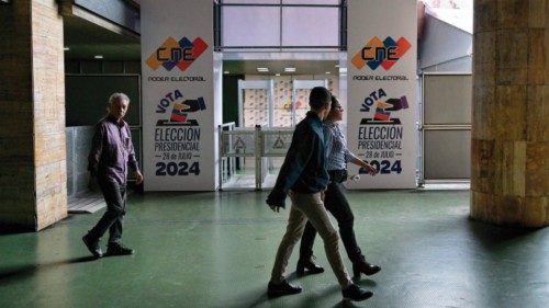 People walk past an information center of the National Electoral Council (CNE) in Caracas on July ... People walk past an information center of the National Electoral Council (CNE) in Caracas on July ...