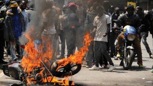 A motorcycle burns as protesters participate in an anti-government demonstration following ... A motorcycle burns as protesters participate in an anti-government demonstration following ...
