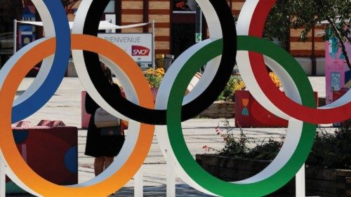Paris 2024 Olympics - Saint-Etienne, France - July 26, 2024 A woman walks next to the Olympic Rings ... Paris 2024 Olympics - Saint-Etienne, France - July 26, 2024 A woman walks next to the Olympic Rings ...